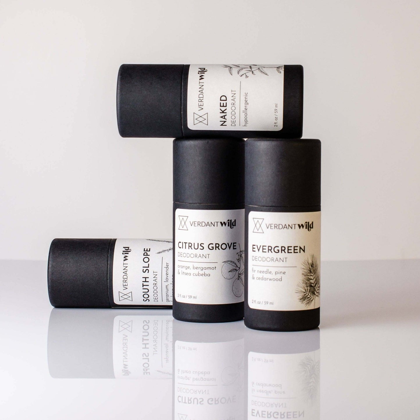 Four non toxic deodorants in black biodegradable tubes with white labels.