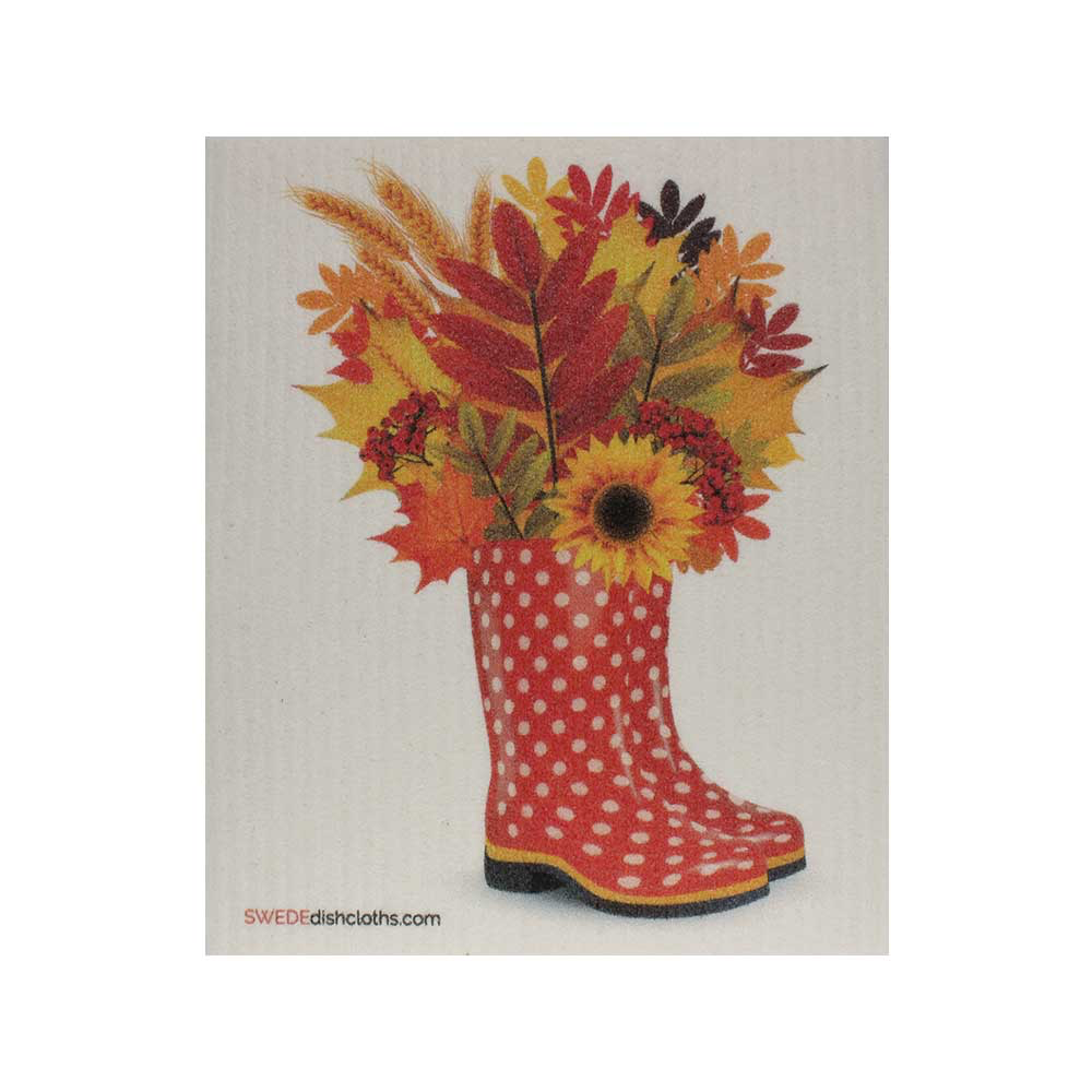 Orange rain boots with white polka dots, and pretty fall colored flowers sticking out of them. 